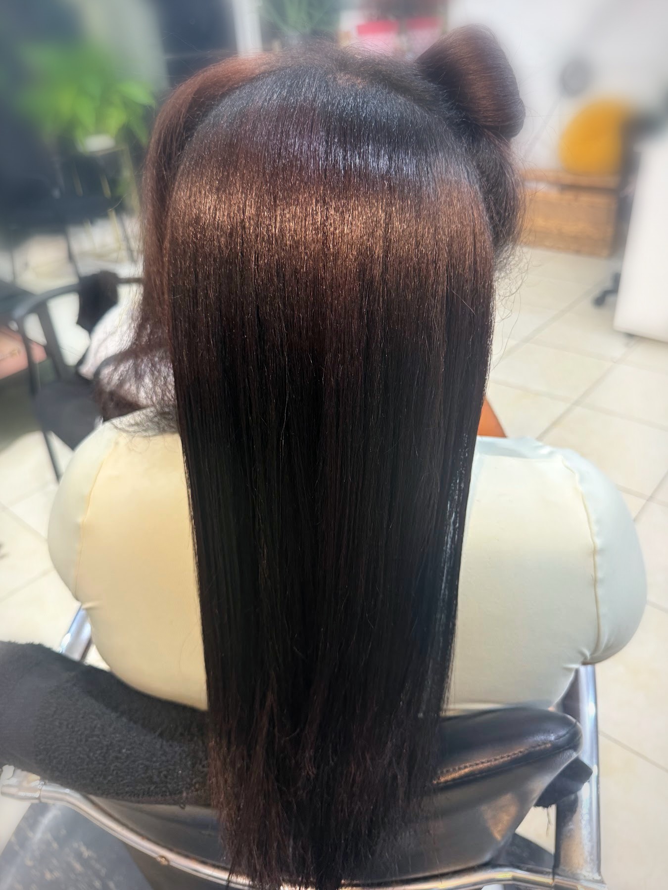 Glossy dark brown silk press on long hair by Johanny, Pompano Beach