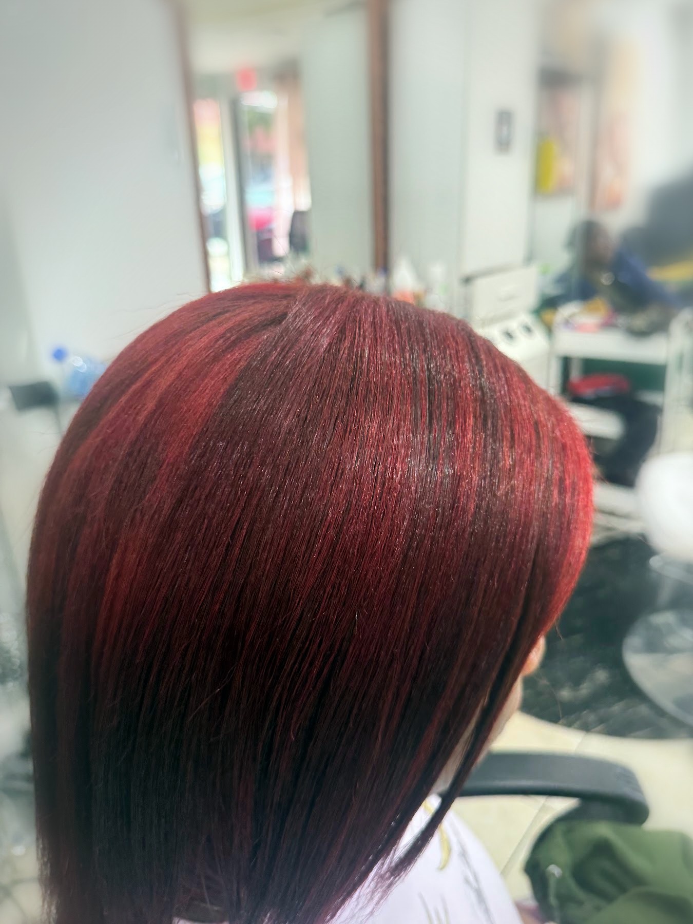 Vivid red color on a sleek straight cut by Johanny, Pompano Beach